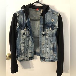 Cropped distressed denim jacket with black hoodie